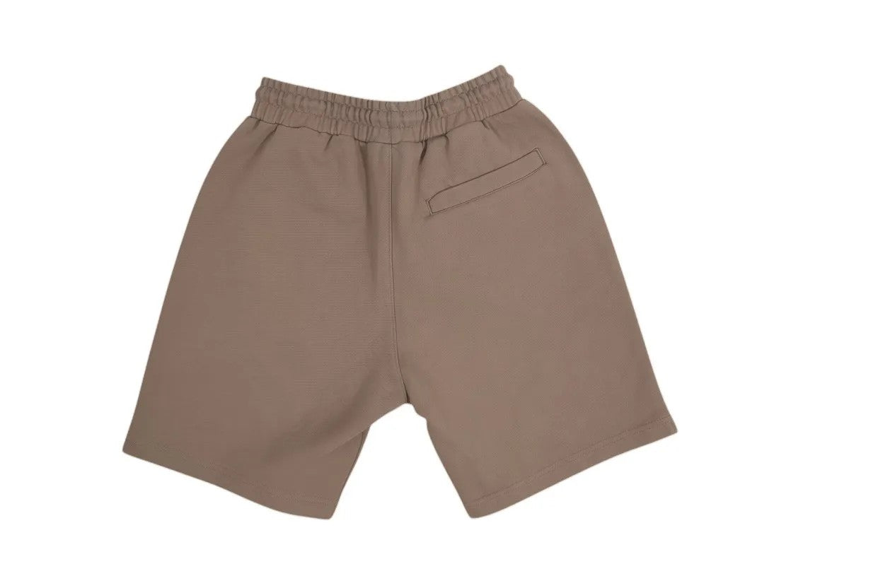 Vallmountbotique beige cotton blend athletic shorts with distressed seams and back pocket.