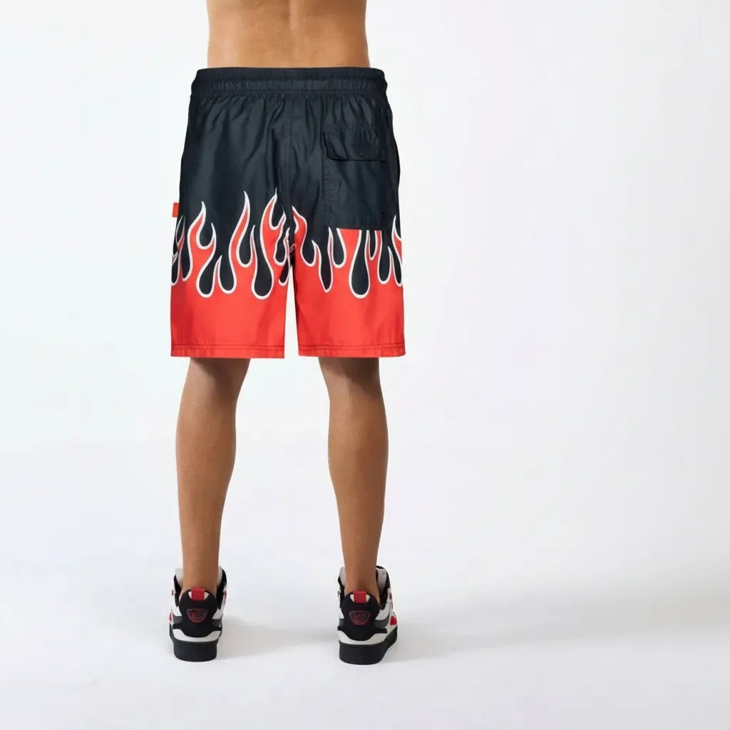Vallmountbotique black swim trunks with red flame print, elastic waistband, and back pocket.
