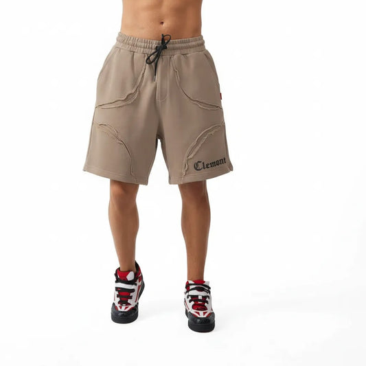 Vallmountbotique beige cotton blend athletic shorts with distressed seams and embroidered logo. Relaxed fit with drawstring waist.