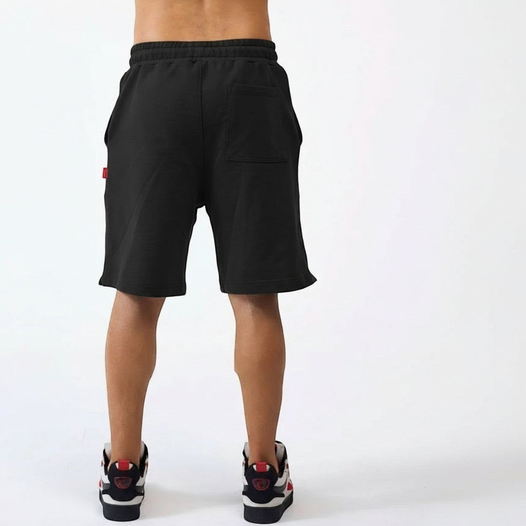 Vallmountbotique black cotton blend athletic sweat shorts with red accent tag and drawstring waist.