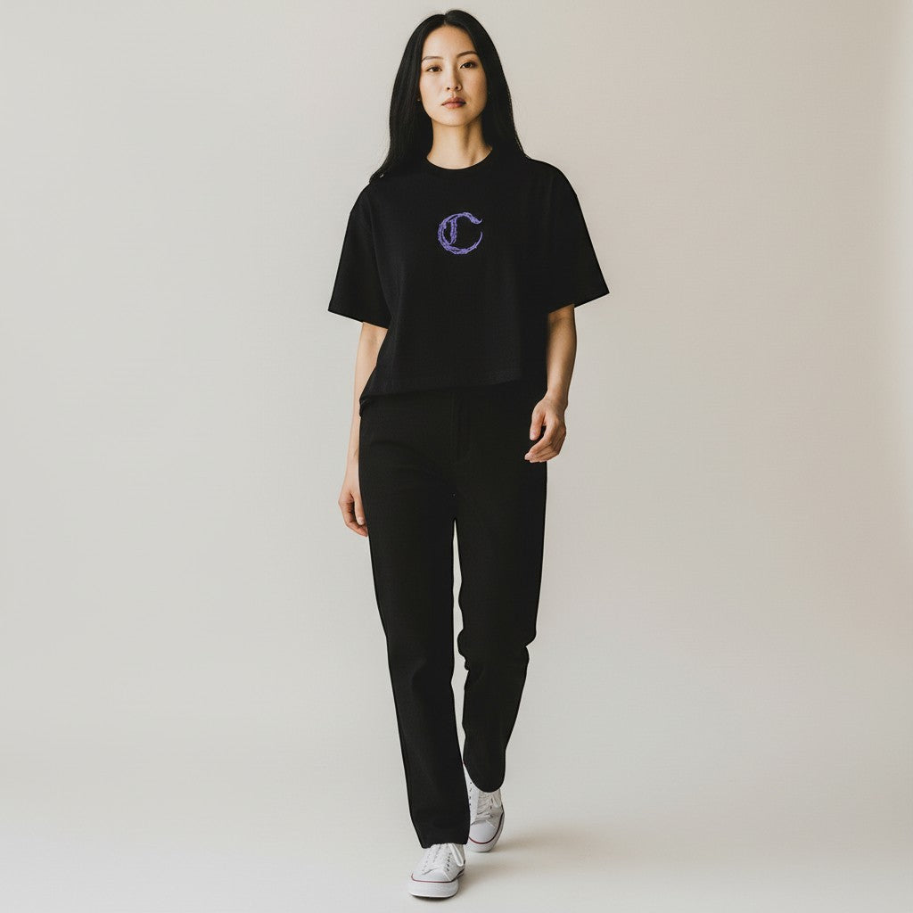 Vallmountbotique black cotton cropped t-shirt with purple embroidered 'C' logo and floral design on back. Oversized fit.