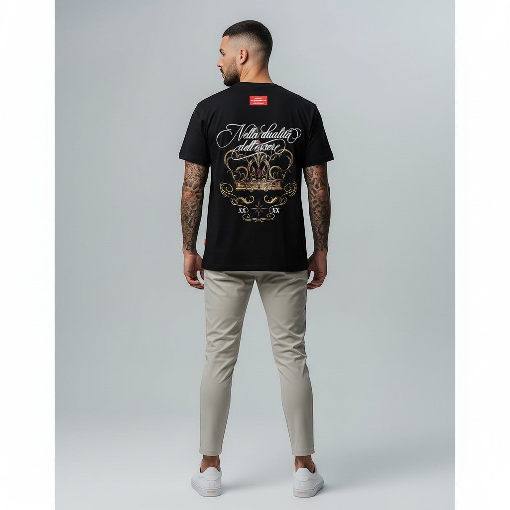Vallmountbotique black cotton t-shirt with a gold crown graphic and ruby red accents. Features script text "Nella dualità dell'essere".