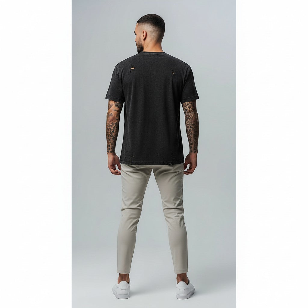 Vallmountbotique black distressed cotton t-shirt with ripped details and subtle embossed logo. Model from behind.