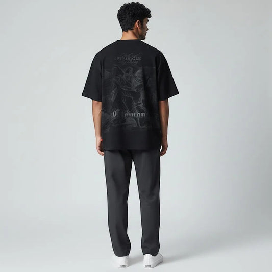 Vallmountbotique black oversized cotton t-shirt with a monochromatic graphic print of angels and the quote "Faith and Struggle Bring Blessing."