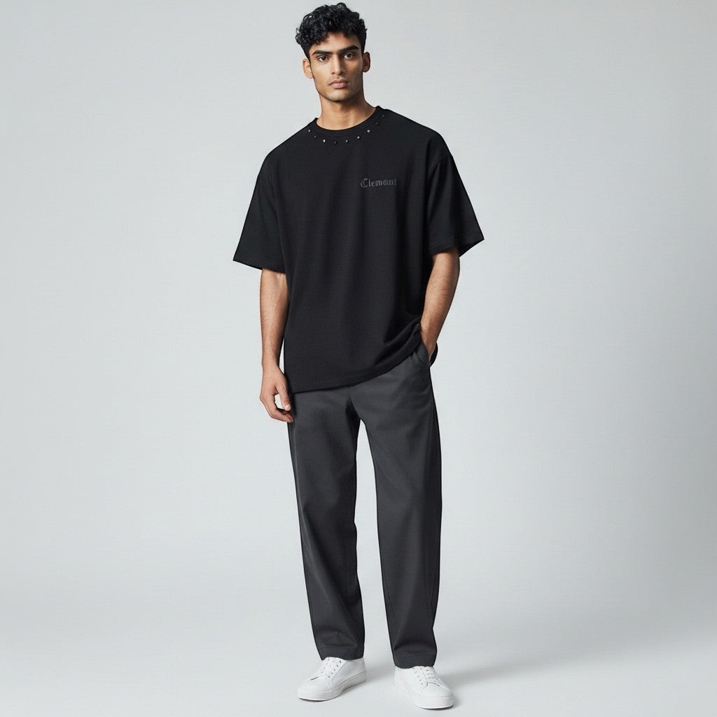 Vallmountbotique black oversized cotton t-shirt with studded neckline and embroidered gothic logo on chest.