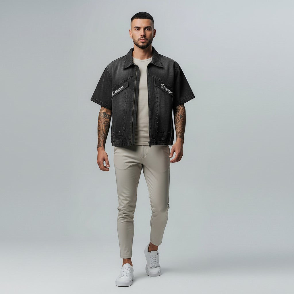 Vallmountbotique charcoal wash denim work shirt with short sleeves and zip front, worn by a man with tattoos.