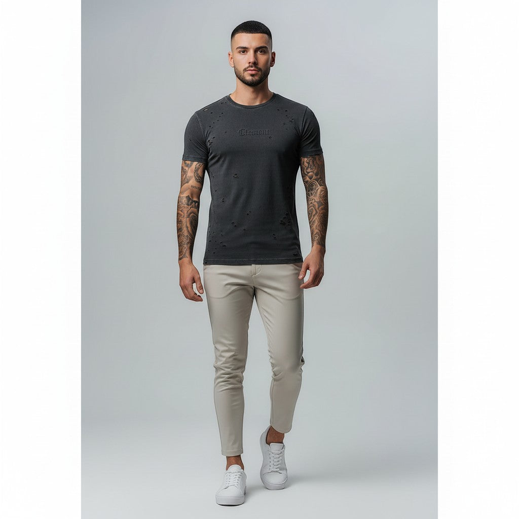 Vallmountbotique distressed charcoal grey cotton t-shirt with ripped details and embossed logo on a male model.