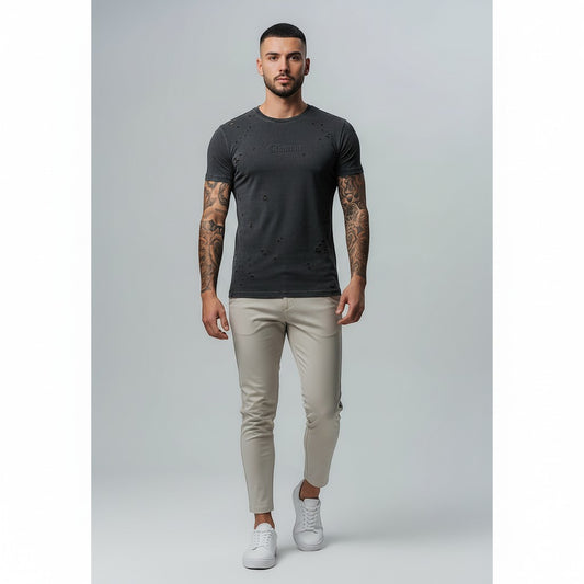 Vallmountbotique distressed charcoal grey cotton t-shirt with ripped details and embossed logo on a male model.