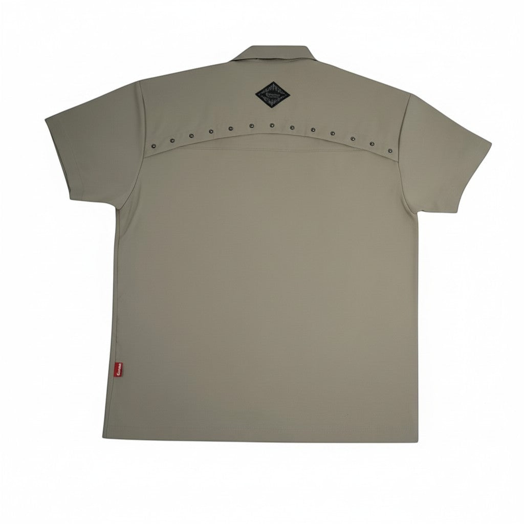 Vallmountbotique khaki short sleeve button-up shirt with grommet detailing on the yoke and embroidered logo.