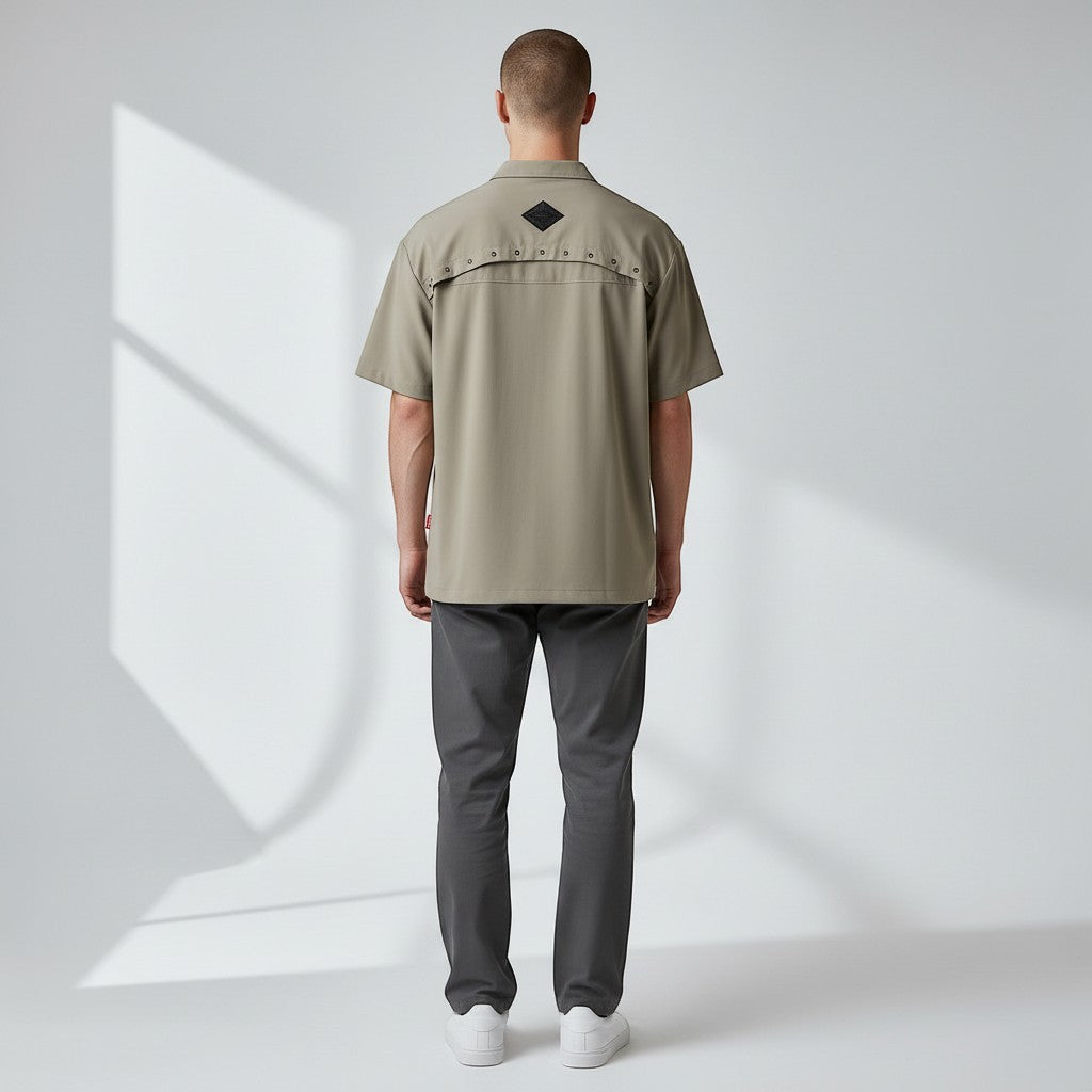 Vallmountbotique khaki short sleeve button-up shirt with decorative grommets on the back yoke and embroidered logo.