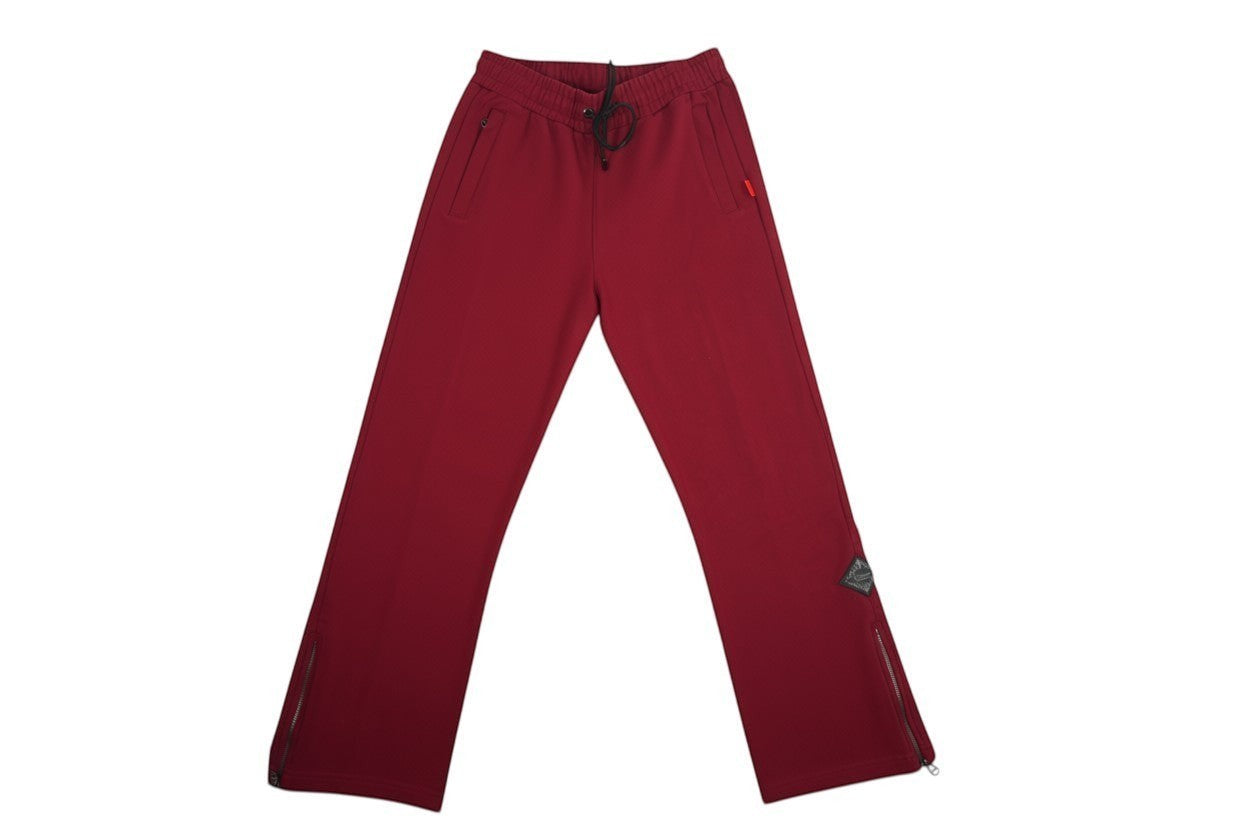 Vallmountbotique maroon wide leg track pants with drawstring waist, zippered ankles, and side pockets.