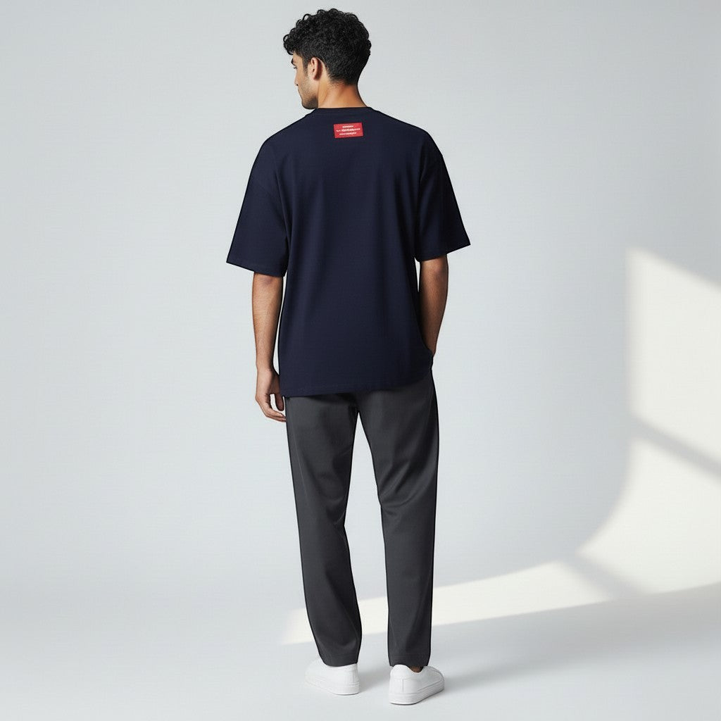 Vallmountbotique navy blue oversized cotton t-shirt with studded neckline and embroidered logo on chest.