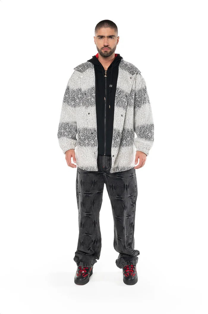 Vallmountbotique men's black and white striped hooded jacket with red lining, layered over a black hoodie and dark wash jeans.
