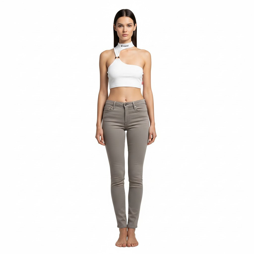 vallmountbotique white one-shoulder crop top with metal ring cutout and grey skinny jeans.