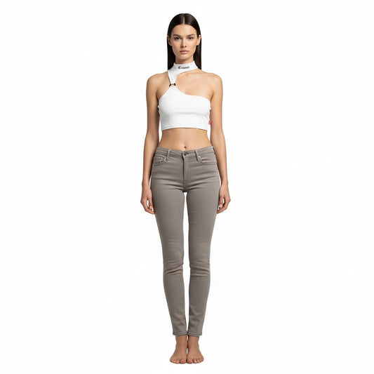 vallmountbotique white one-shoulder crop top with metal ring cutout and grey skinny jeans.