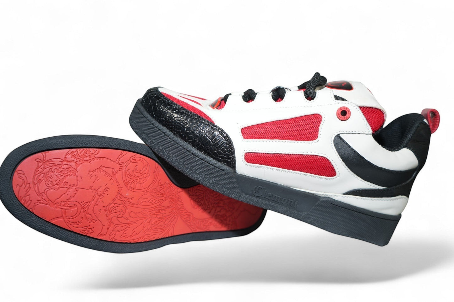 vallmountbotique white, red, and black leather sneakers with black laces and a textured toe box. Red sole features ornate detailing.